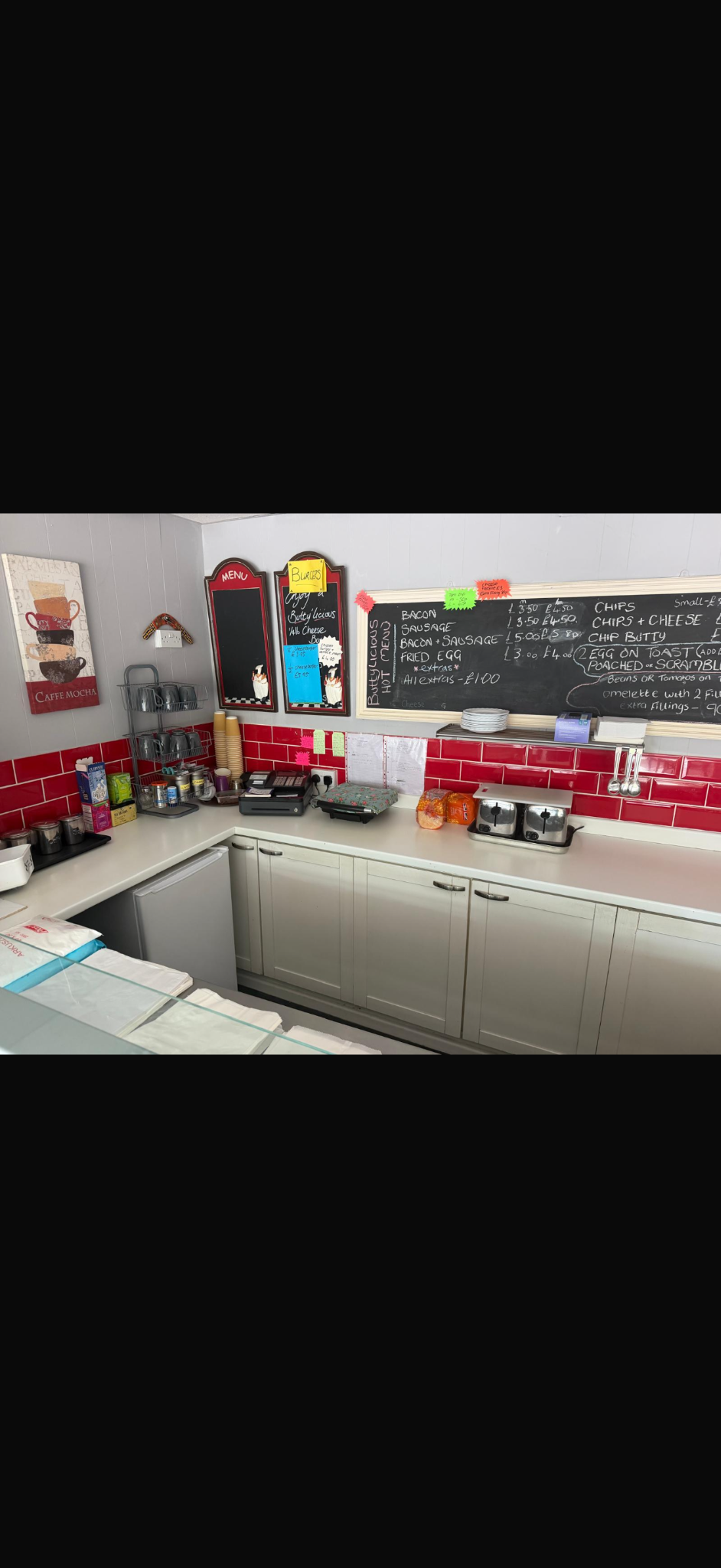 The café counter and menu boards inside Blossoms Butties